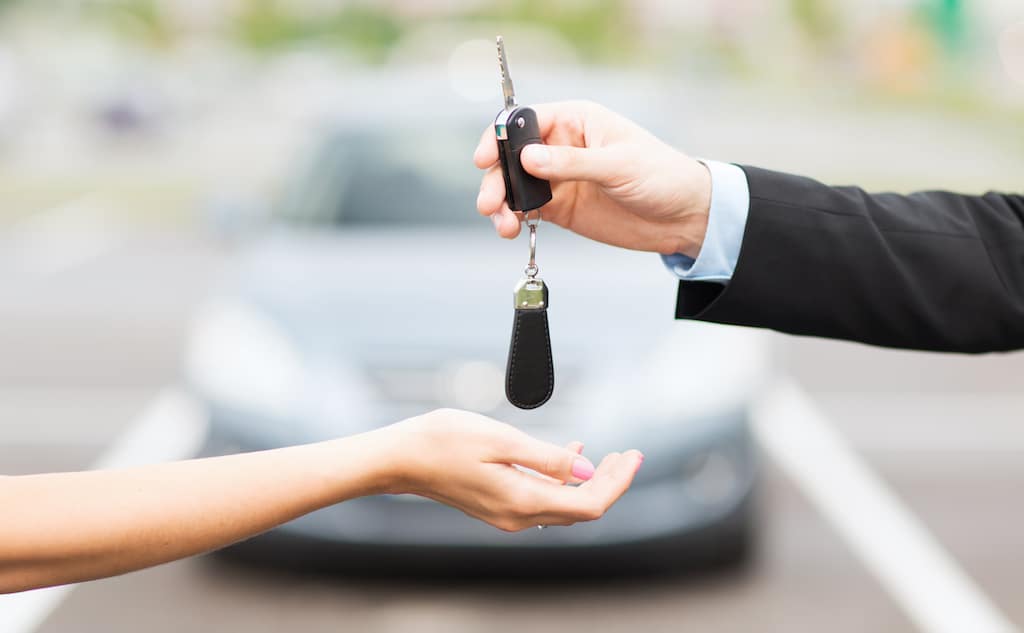 Transportation Ownership Concept Customer Salesman With Car Key Outside